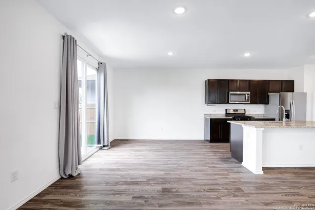 a view of kitchen with microwave and cabinets