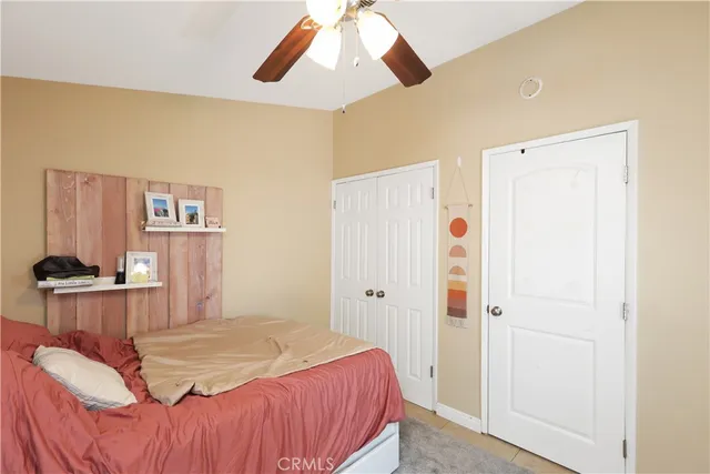 a spacious bedroom with a bed and a chandelier