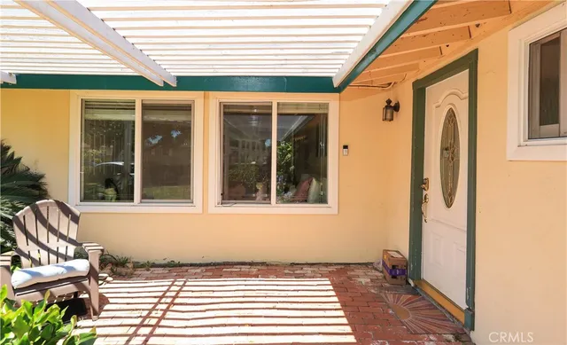 a view of a patio with a dining table and chairs