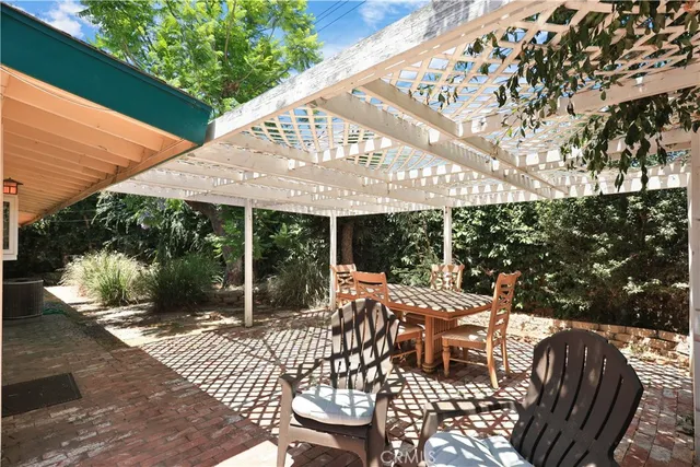 a view of a house with backyard porch and sitting area