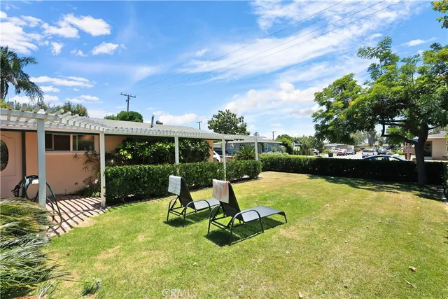 a view of a house with backyard and sitting area