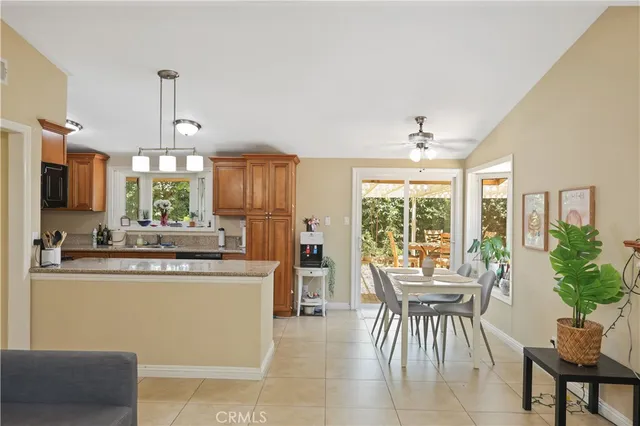 a kitchen with kitchen island granite countertop wooden cabinets and dining table