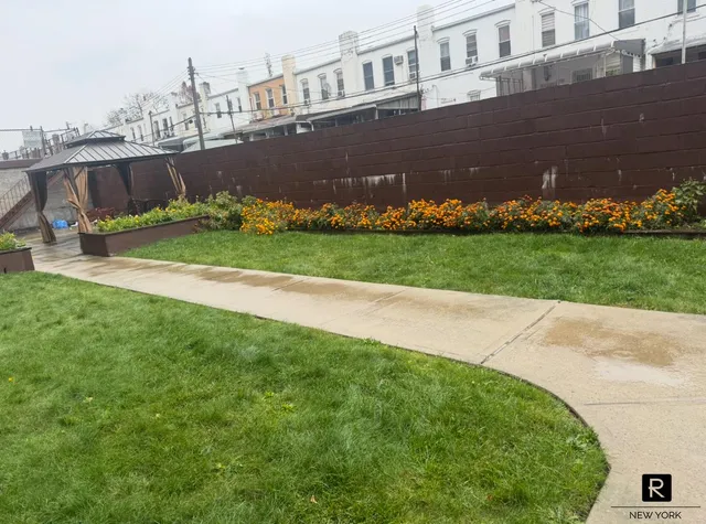 a view of a house with a big yard and potted plants