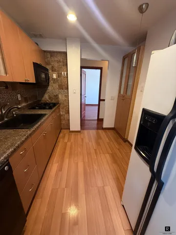 a kitchen with wooden floors and a sink
