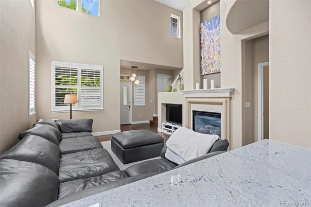 a living room with furniture fireplace and window