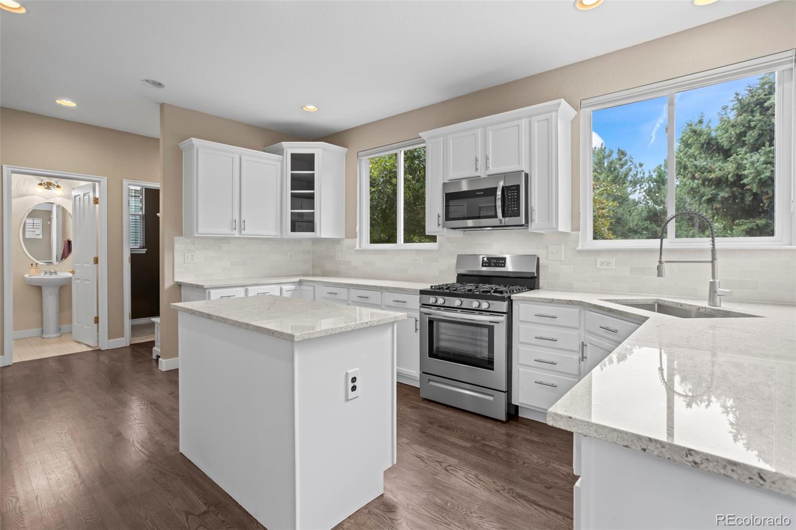 10704 Riverbrook Circle Highlands Ranch, CO 80126 - Photo 19 of 40 a kitchen with granite countertop a stove and a sink