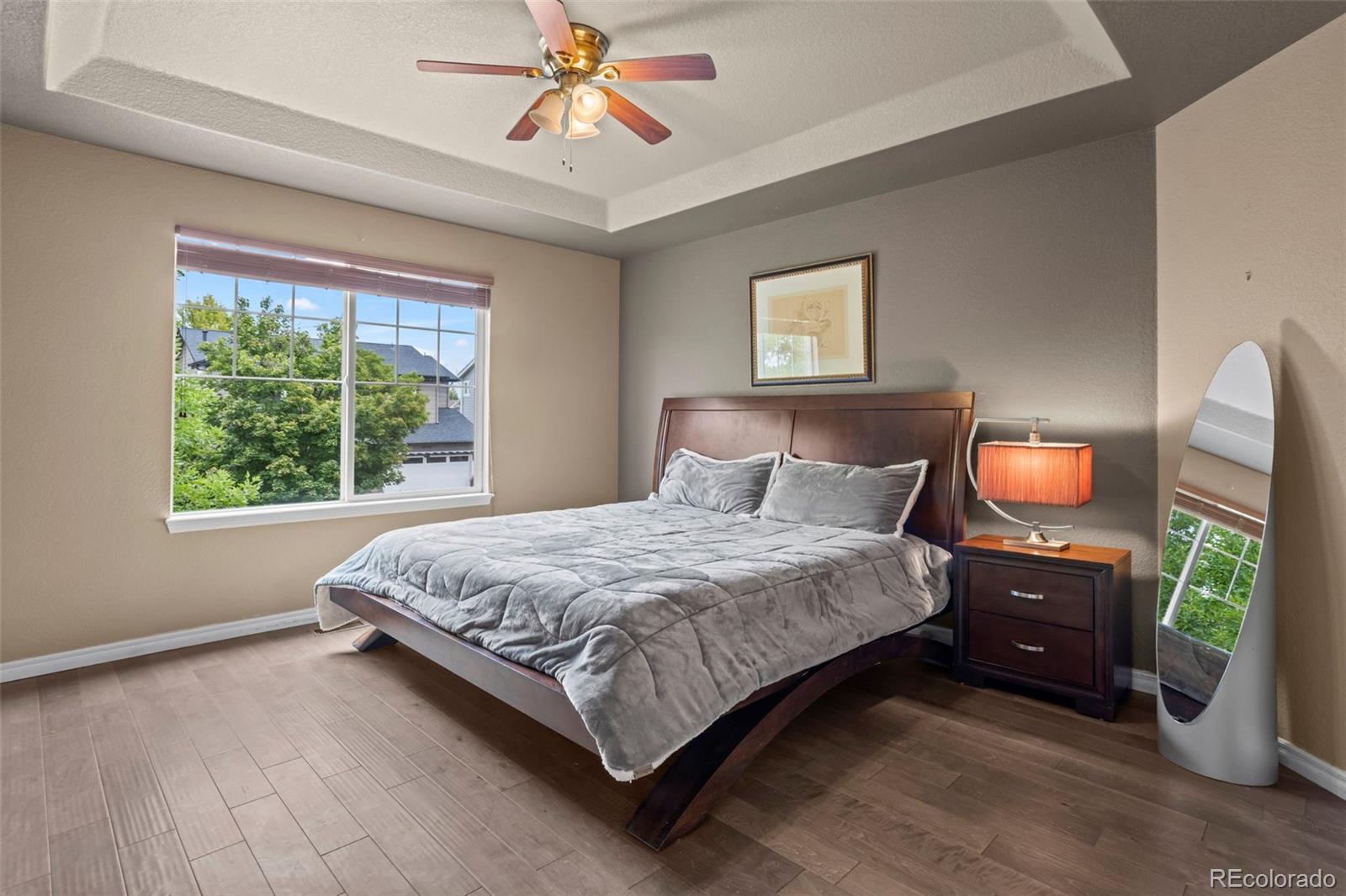 10704 Riverbrook Circle Highlands Ranch, CO 80126 - Photo 29 of 40 a bedroom with a bed and a chandelier