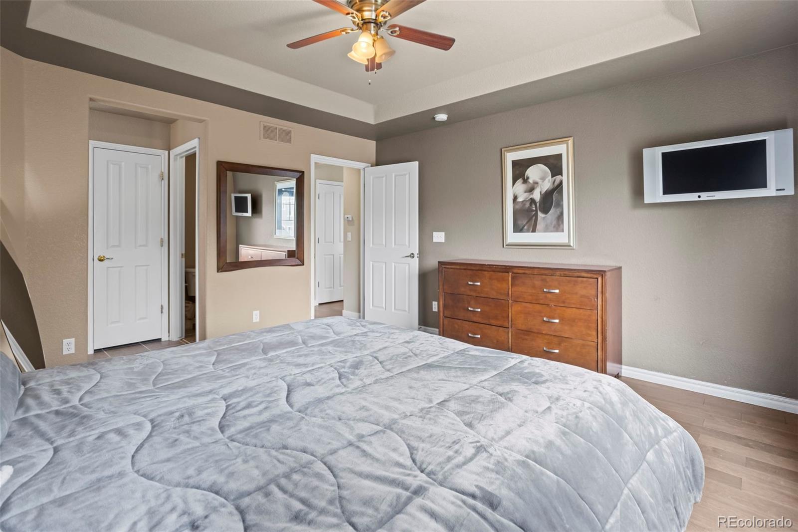 10704 Riverbrook Circle Highlands Ranch, CO 80126 - Photo 30 of 40 a bedroom with a large bed and a chandelier