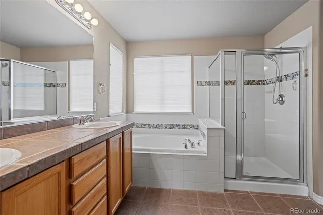 a bathroom with a granite countertop sink a toilet and shower