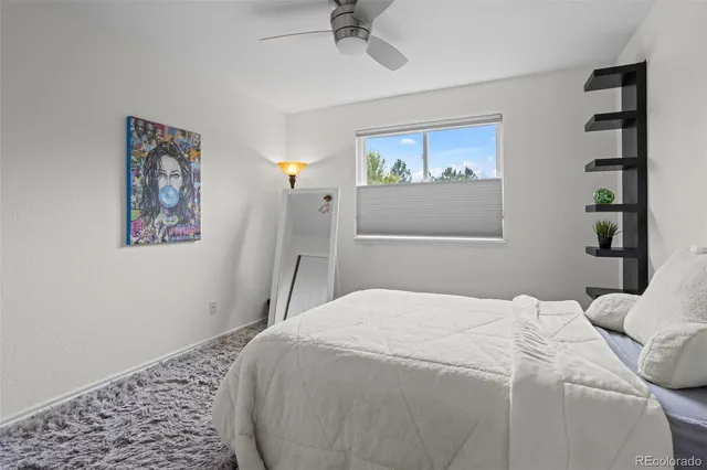 a bedroom with a bed and a painting on the wall