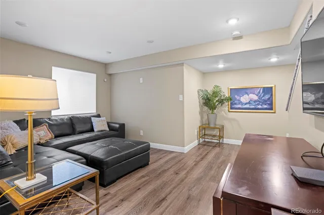 a living room with furniture and wooden floor