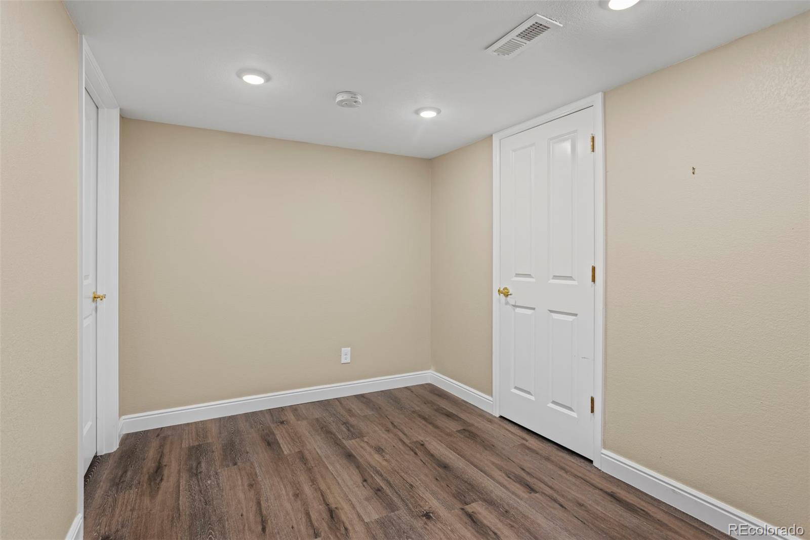 10704 Riverbrook Circle Highlands Ranch, CO 80126 - Photo 38 of 40 a view of an empty room with wooden floor