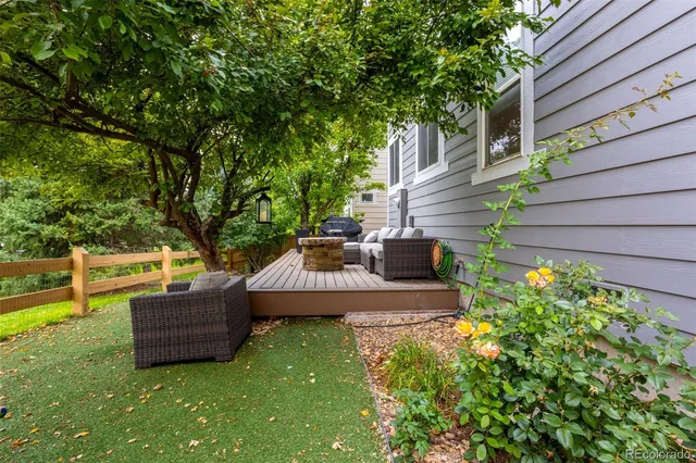 a view of a backyard with couches chair and grass