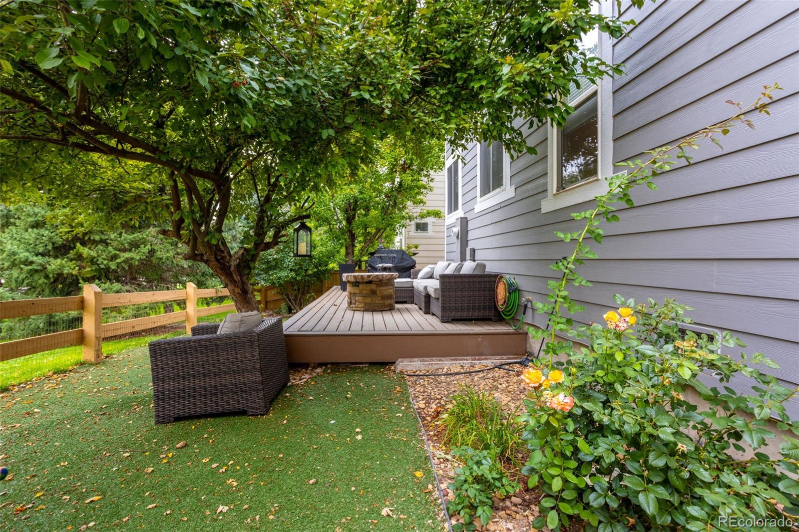 10704 Riverbrook Circle Highlands Ranch, CO 80126 - Photo 6 of 40 a view of a backyard with couches chair and grass
