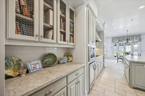 a kitchen with stainless steel appliances granite countertop a sink and a refrigerator