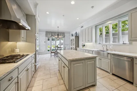 a kitchen that has a lot of cabinets in it and wooden cabinets