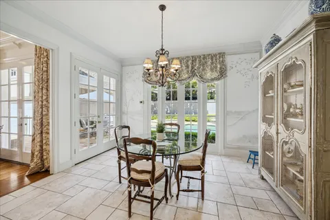 a dining room with furniture and chandelier