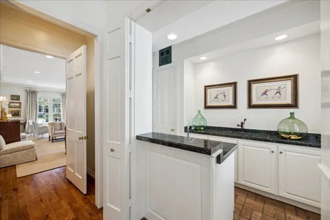 a kitchen with granite countertop a sink and cabinets
