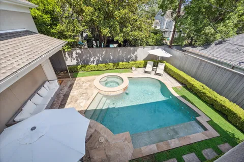 a view of a backyard with furniture and outdoor seating