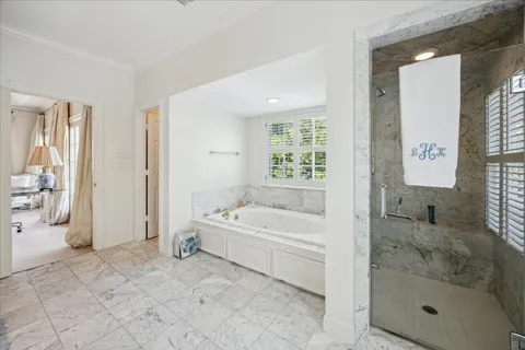 a spacious bathroom with a bathtub and a shower