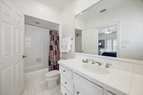 a bathroom with a sink toilet tub and shower