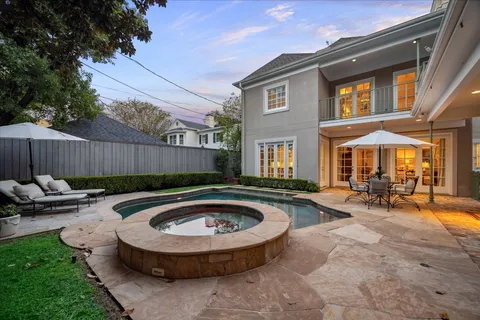 a view of swimming pool with patio in the backyard