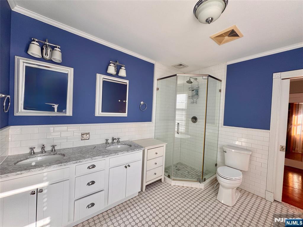 232 Franklin Turnpike Allendale, NJ 07401 - Photo 14 of 30 a bathroom with a granite countertop toilet sink shower and mirror