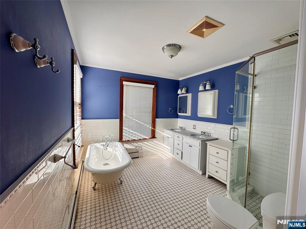 232 Franklin Turnpike Allendale, NJ 07401 - Photo 15 of 30 a bathroom with a sink a toilet a mirror and shower