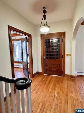 a view of entryway with a door and wooden floor
