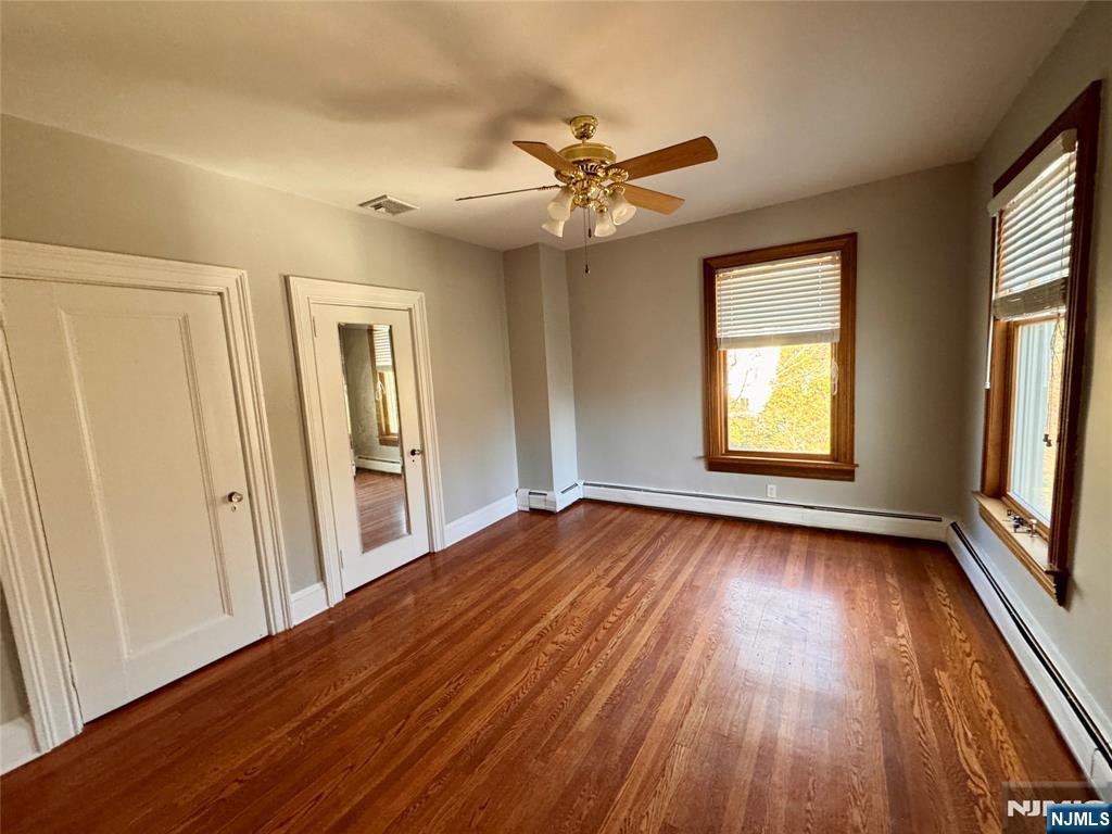 232 Franklin Turnpike Allendale, NJ 07401 - Photo 21 of 30 an empty room with wooden floor fan and windows
