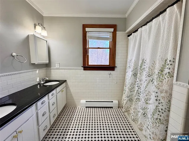 a bathroom with a granite countertop sink a toilet a mirror a vanity and shower
