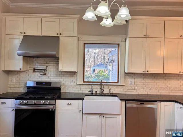 a kitchen with cabinets a stove and a sink
