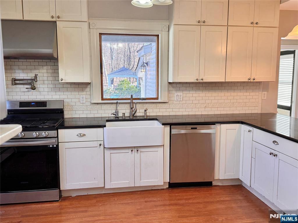 232 Franklin Turnpike Allendale, NJ 07401 - Photo 9 of 30 a kitchen with cabinets appliances a sink and a window