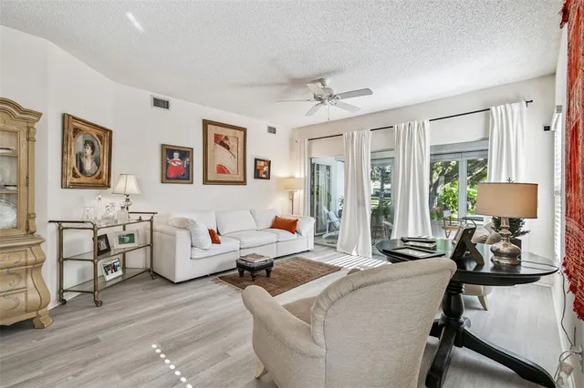 a living room with furniture and large windows