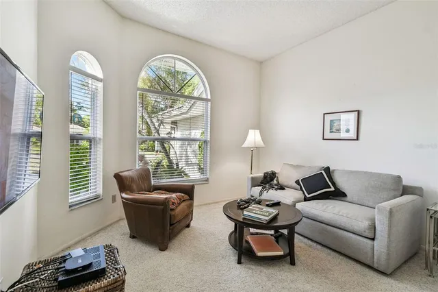 a living room with furniture and a large window