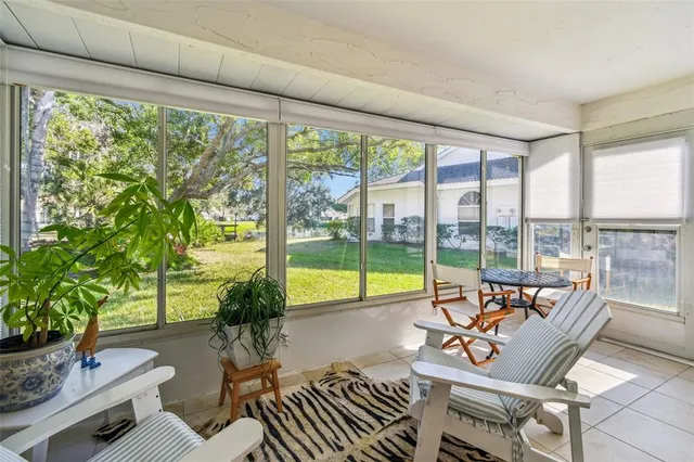 a living room with furniture and floor to ceiling windows
