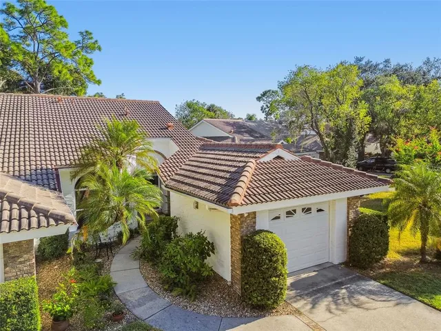 an aerial view of a house with a garden and plants