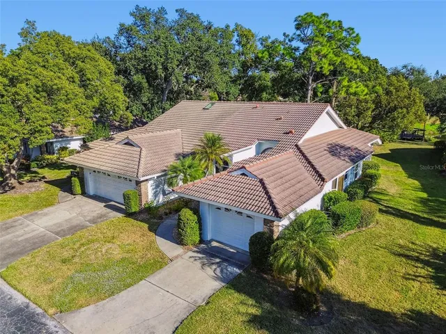 an aerial view of a houses with a yard