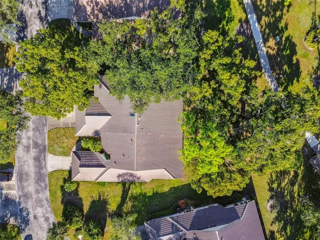 an aerial view of residential houses with outdoor space and lake view
