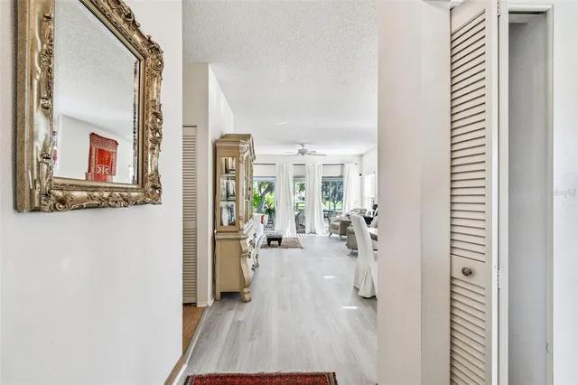 a view of a hallway with a dining table and chairs