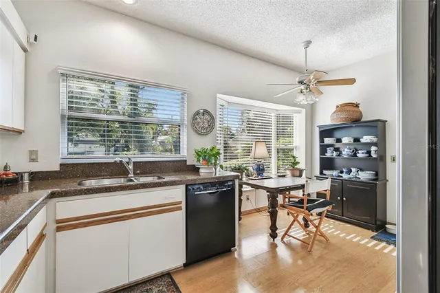 a kitchen with a stove a sink a counter space dining table and chairs