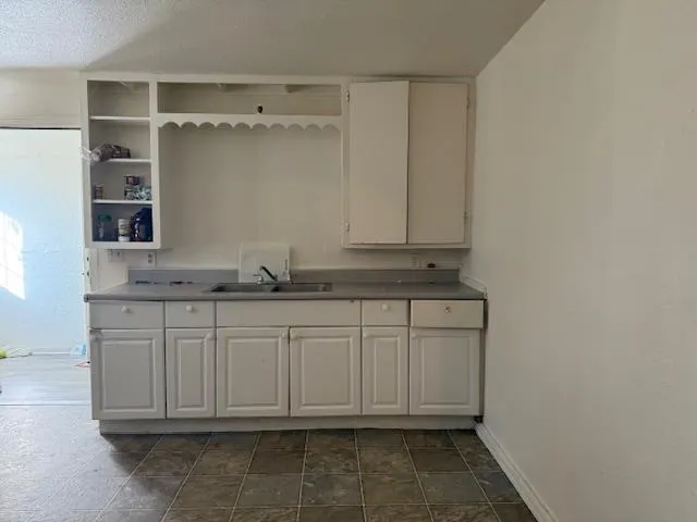 a bathroom with a sink and cabinets