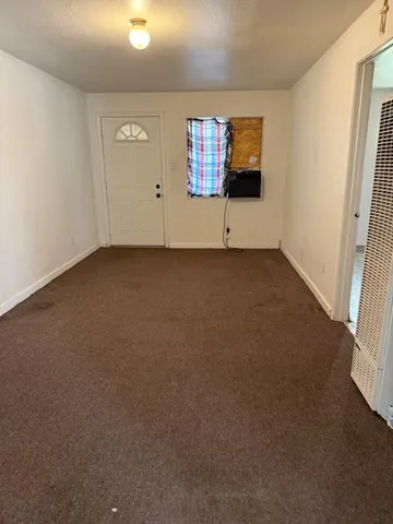 an empty room with windows and closet