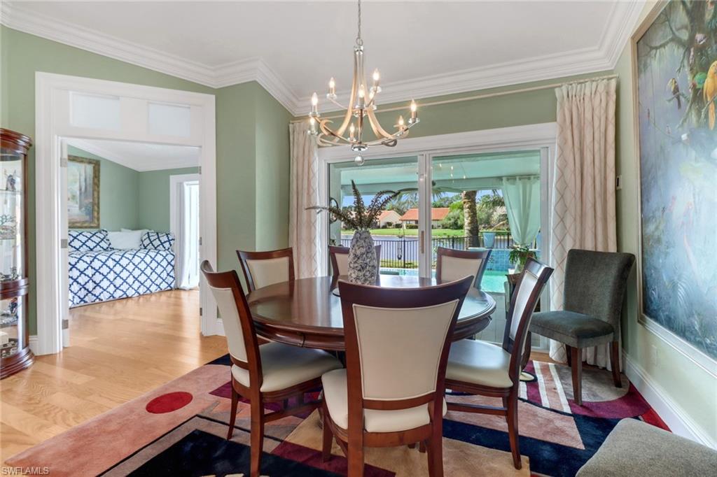 310 Fox Den Circle Naples, FL 34104 - Photo 13 of 46 a view of a dining room with furniture and a chandelier