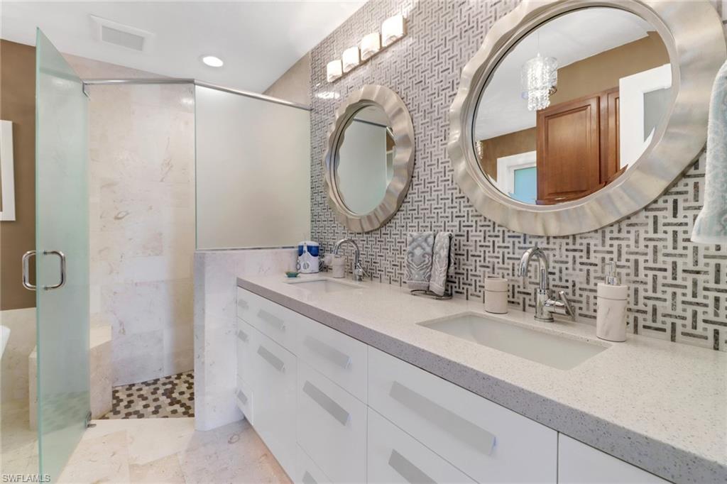 310 Fox Den Circle Naples, FL 34104 - Photo 18 of 46 a bathroom with a sink and a mirror