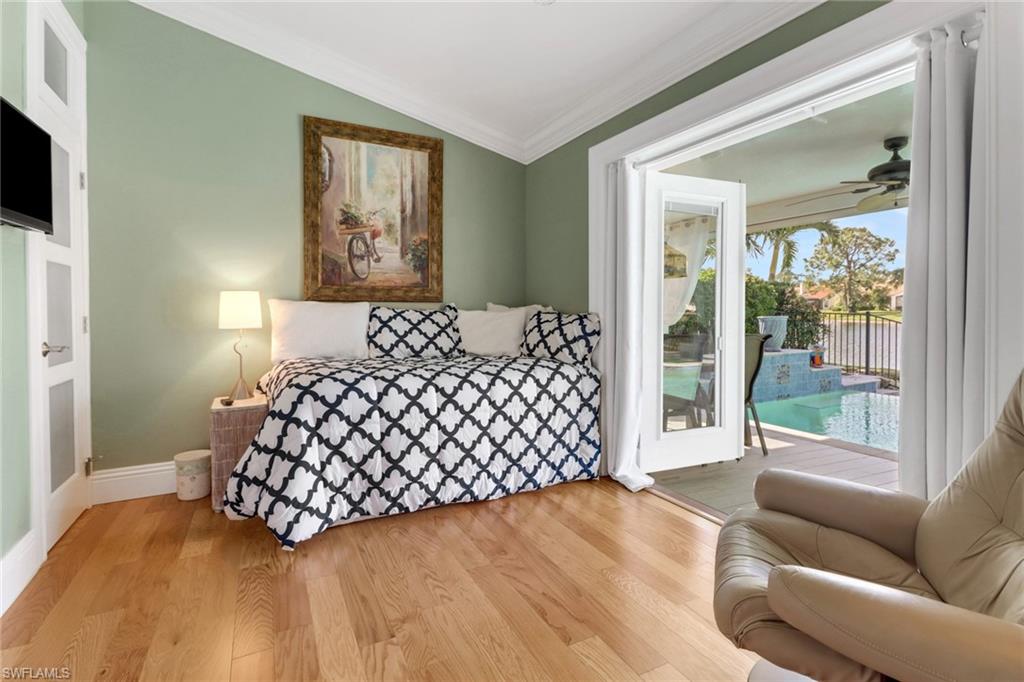 310 Fox Den Circle Naples, FL 34104 - Photo 19 of 46 a bedroom with a bed couch and window