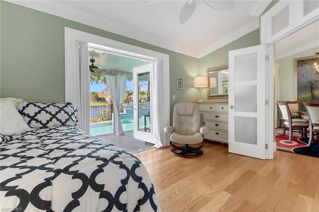 310 Fox Den Circle Naples, FL 34104 - Photo 20 of 46 a bedroom with a bed and a large window