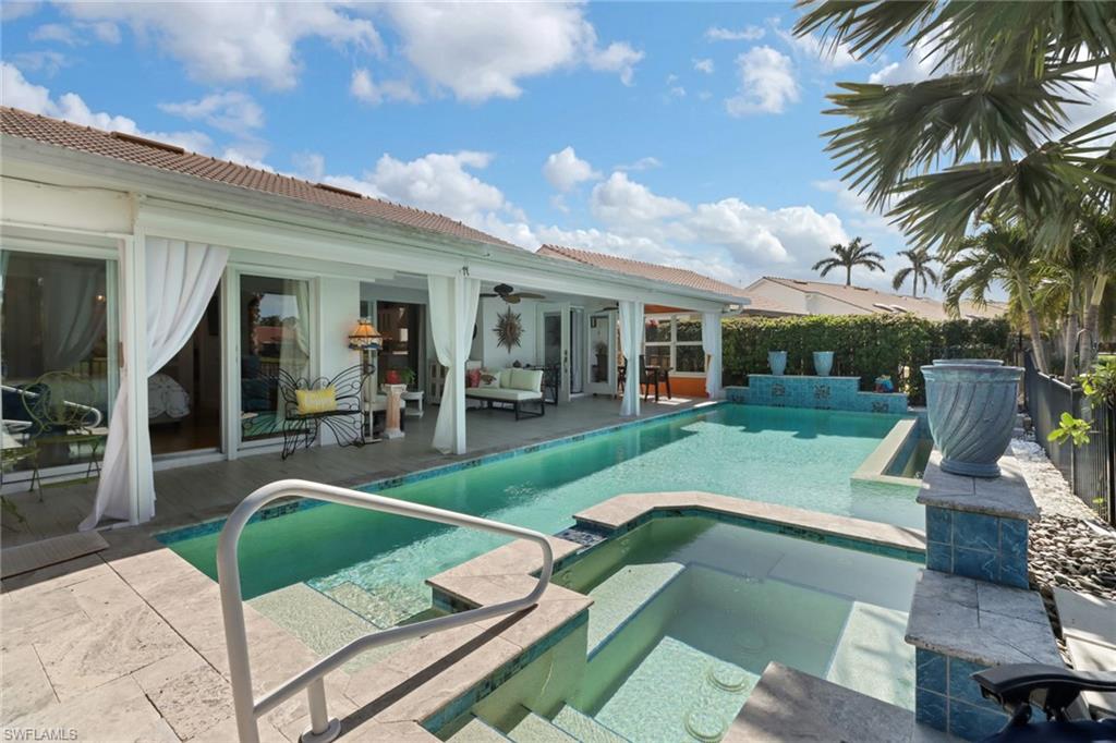 310 Fox Den Circle Naples, FL 34104 - Photo 28 of 46 a view of a house with backyard patio and swimming pool
