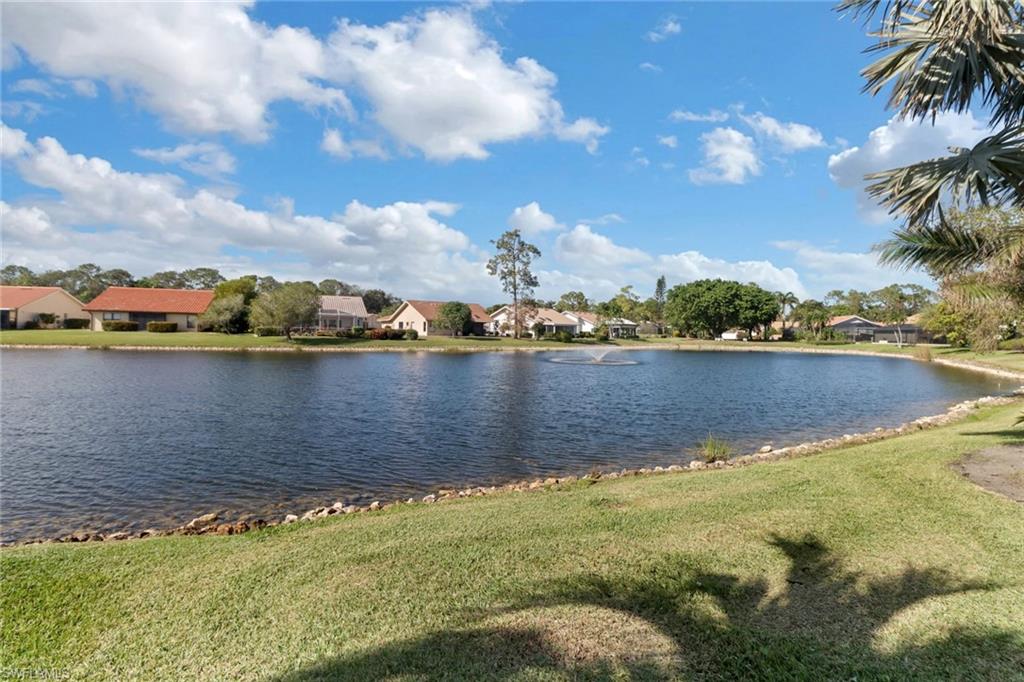 310 Fox Den Circle Naples, FL 34104 - Photo 29 of 46 a view of a lake with houses in the background