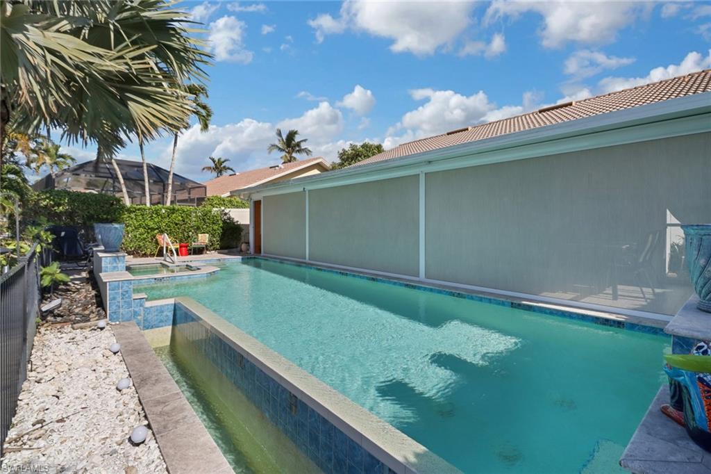 310 Fox Den Circle Naples, FL 34104 - Photo 44 of 46 a backyard with potted plants and a large tree